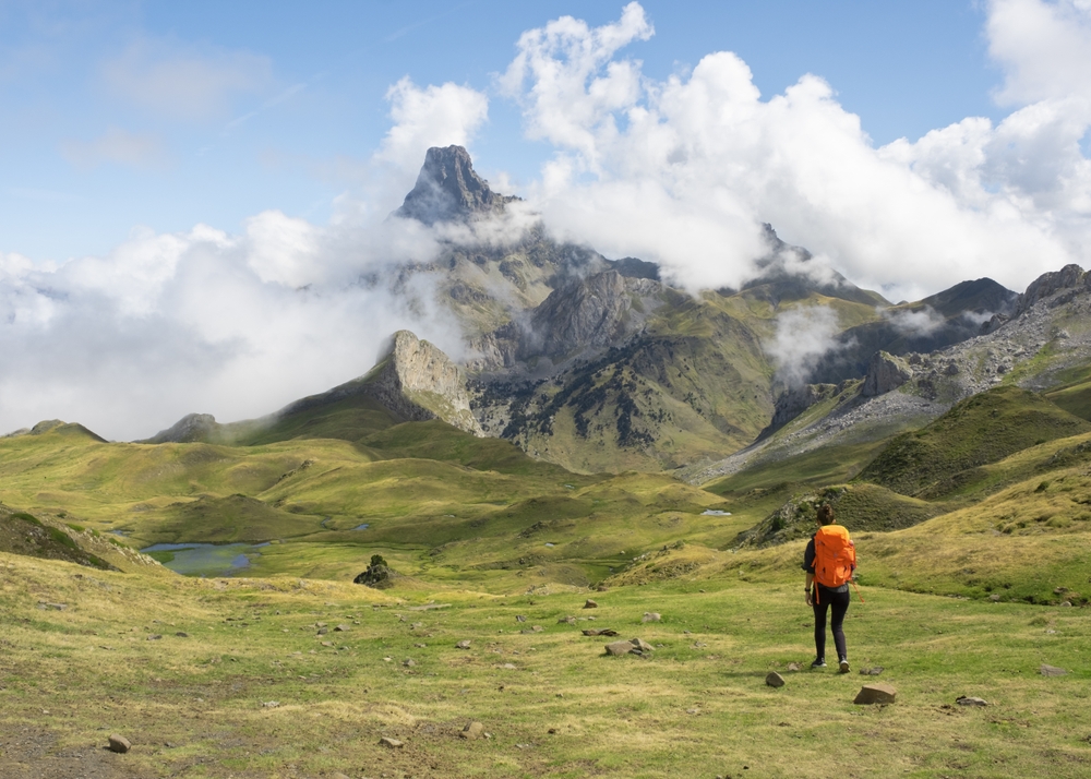 Girl,With,Backpack,Hiking,,Midi,Dossau,Peak,In,The,Background